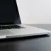 silver laptop computer on black table